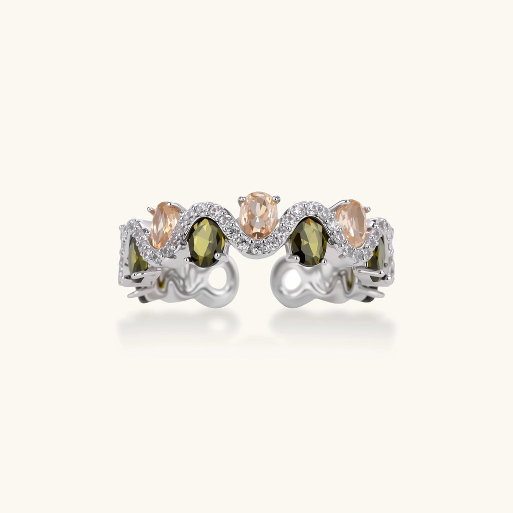 Adjustable copper ring with platinum plating, featuring alternating peach and green zirconia stones in organic wave pattern