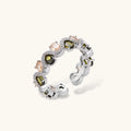 Adjustable copper ring with platinum plating, featuring alternating peach and green zirconia stones in organic wave pattern